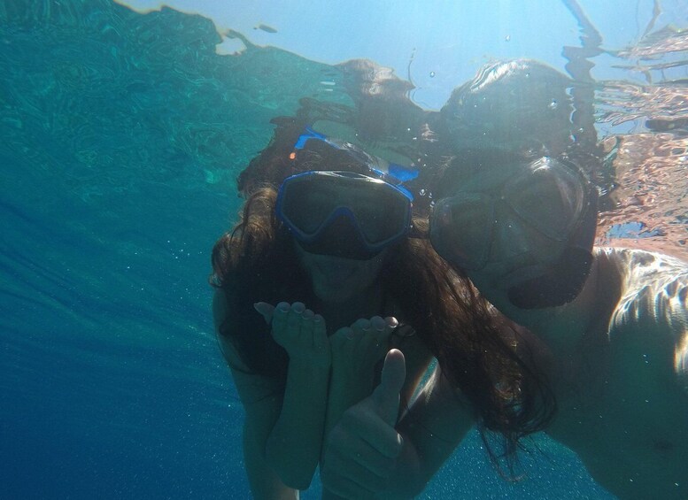 Two people snorkeling underwater. 4