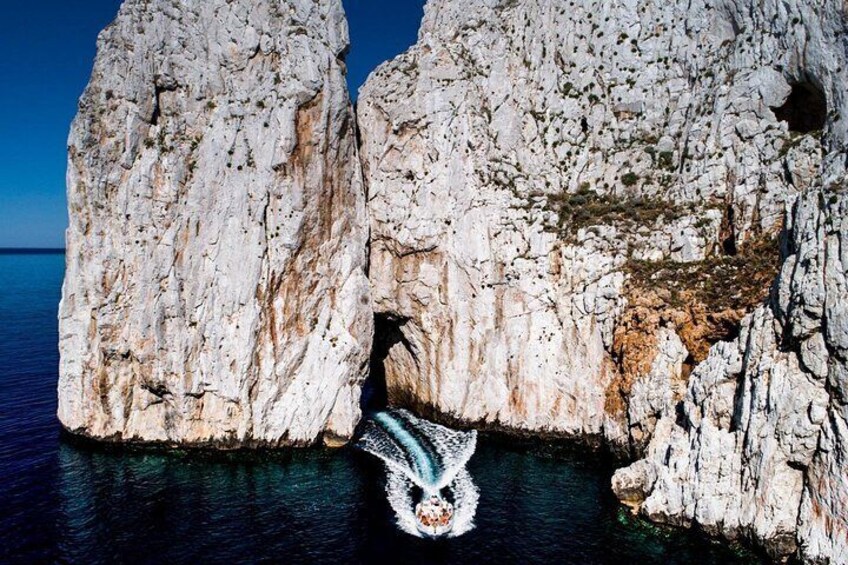 A rocky coastline with a cave entrance. 1