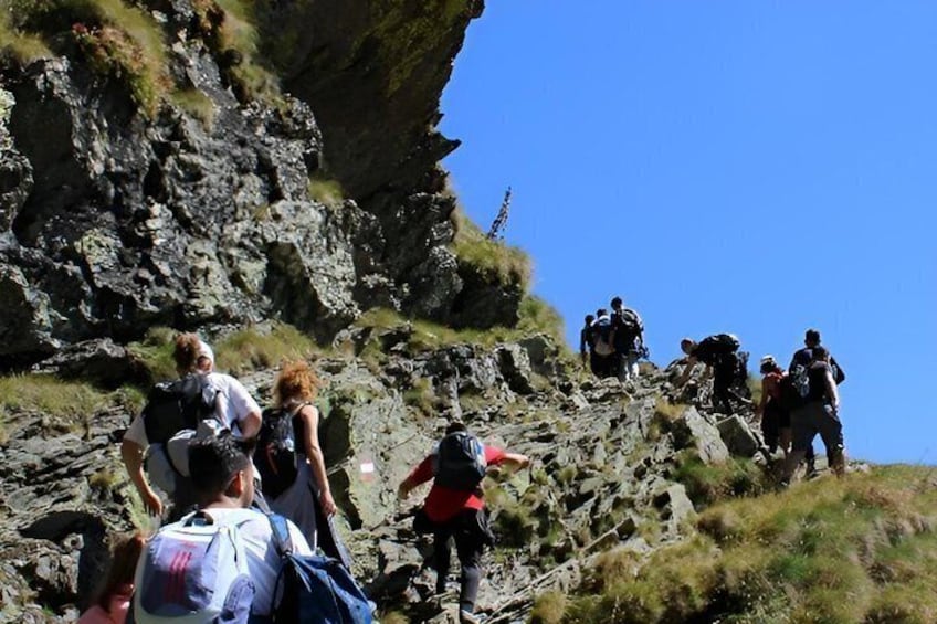 Hikers ascending a rocky mountain path. 2