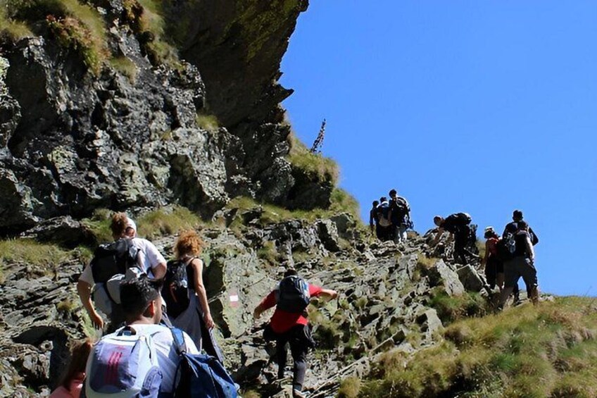 Hikers ascending a rocky mountain slope. 2