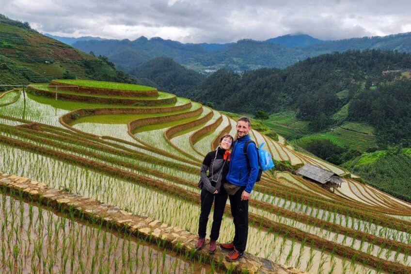 Terraced rice fields, a couple, and a mountainous landscape. 2