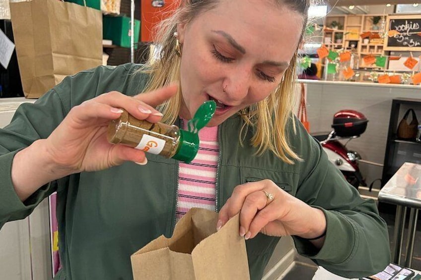 A person holding a bottle and a brown paper bag. 4