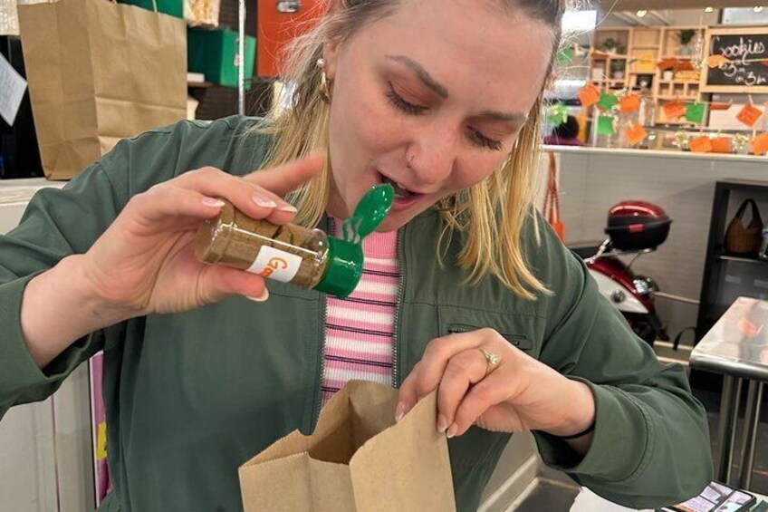 A person holding a bottle and a brown paper bag. 5