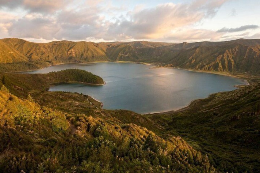 A lake surrounded by mountains, a clear sky, and a forested area. 4