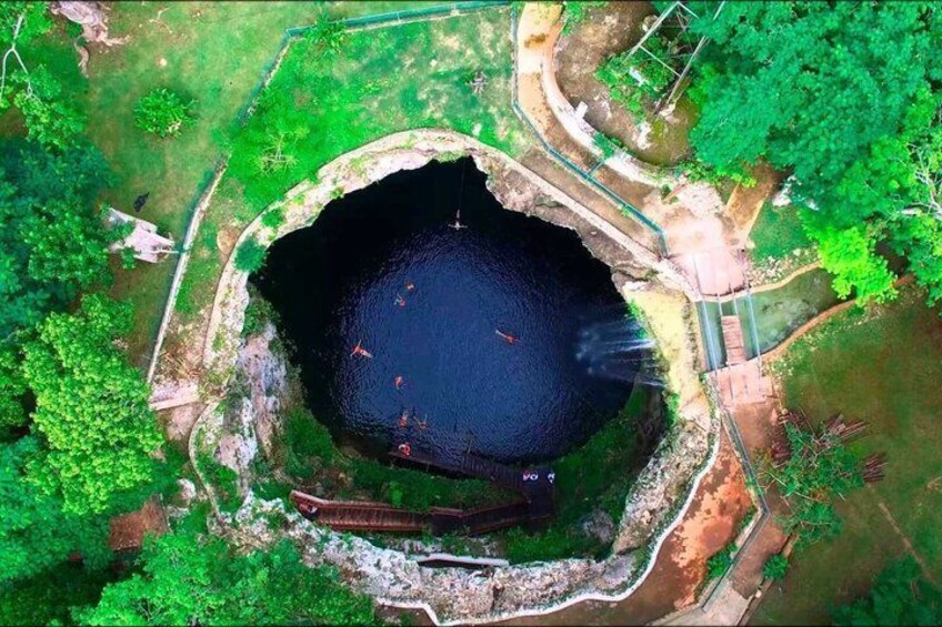 An aerial view of a circular water body surrounded by greenery and a paved walkway. 4
