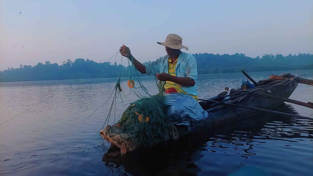 A person fishing from a boat. 4