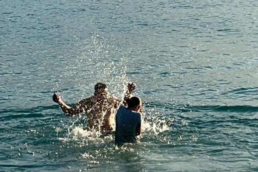 Two people swimming in a body of water. 2