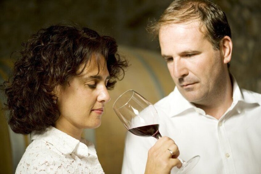 A person holding a wine glass. 1