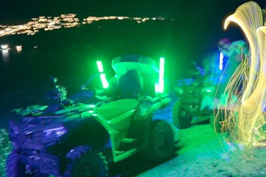 ATVs with green lights parked in a dimly lit area. 5