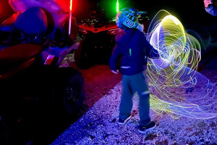 A person with a helmet and a light trail. 5