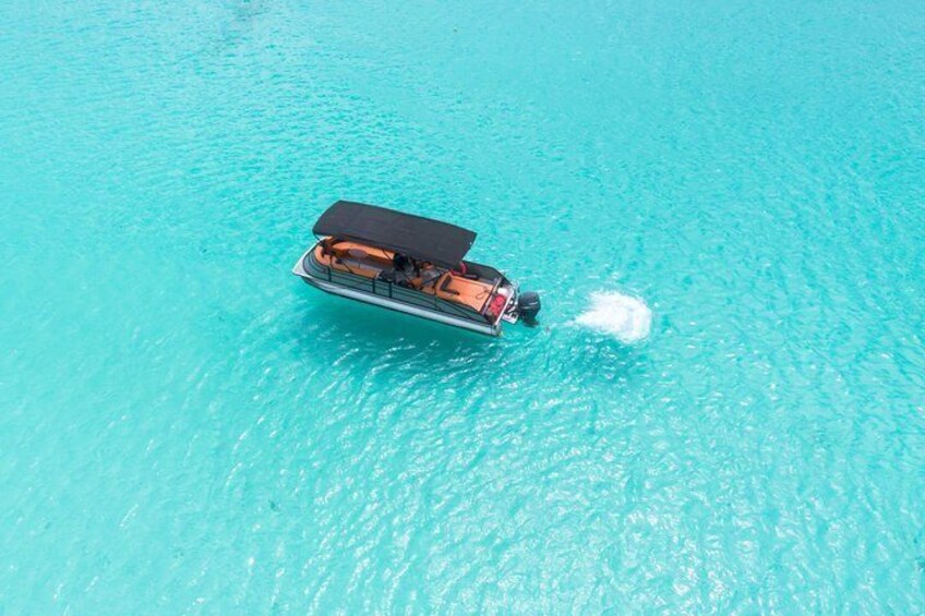 A boat on turquoise water. 1