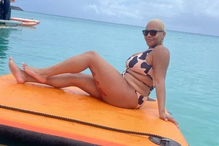 A person sitting on a boat in a body of water. 3