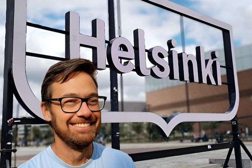 A person standing in front of a sign that reads 'Helsinki.' 4