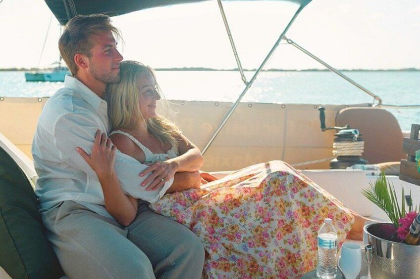 A couple on a boat with a view of the sea and a clear sky. 3