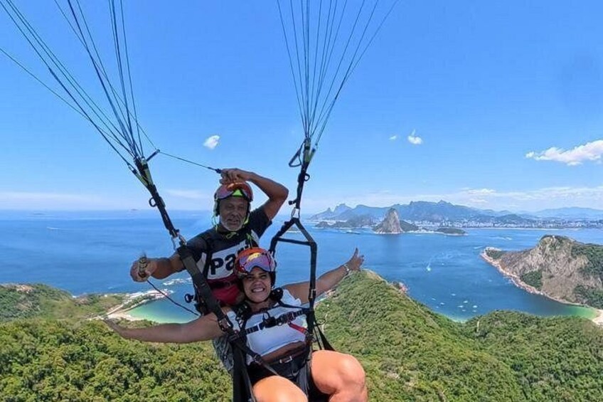 A person paragliding with a scenic coastal landscape in the background. 4