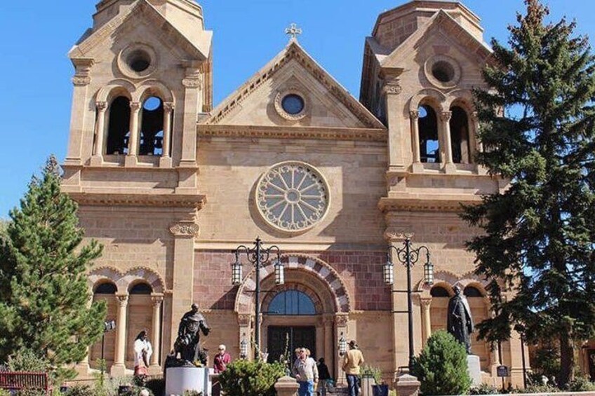 A historic church with a large circular window and two bell towers. 3