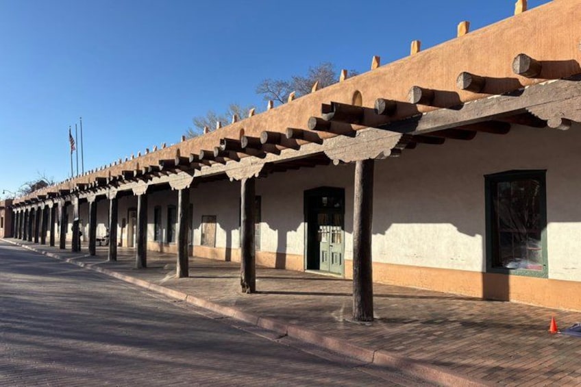 A building with a series of covered walkways and columns. 1