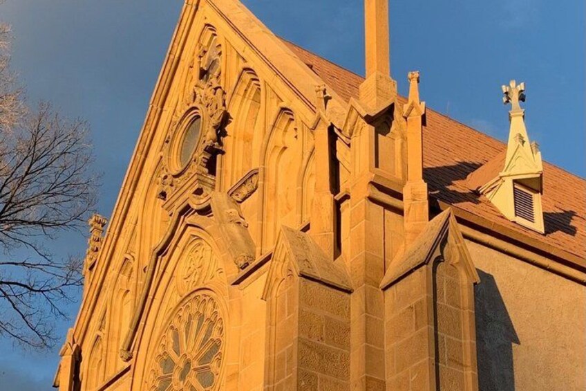 A Gothic-style church with intricate stonework and a large rose window. 2
