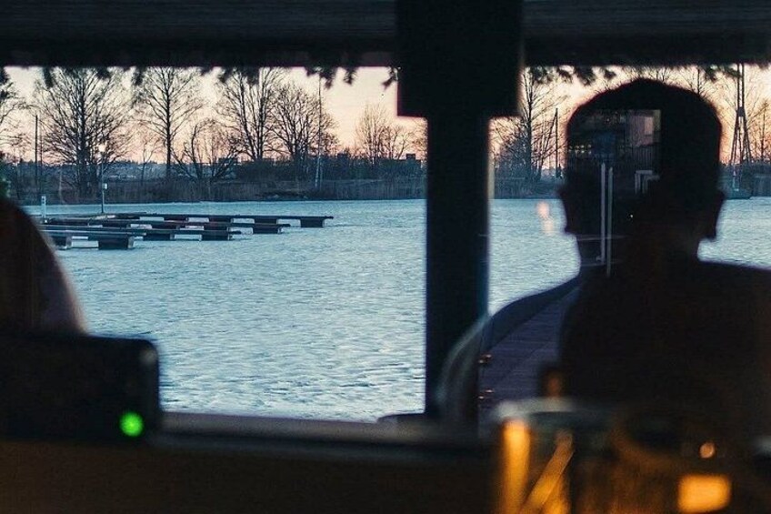 A river with a dock and a sunset in the background. 4