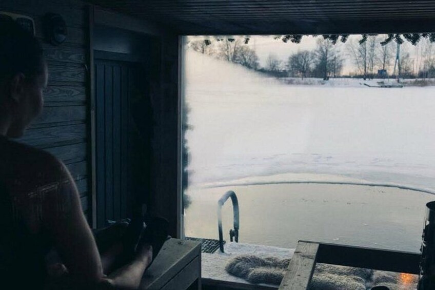 A person standing by a window overlooking a snowy landscape. 2