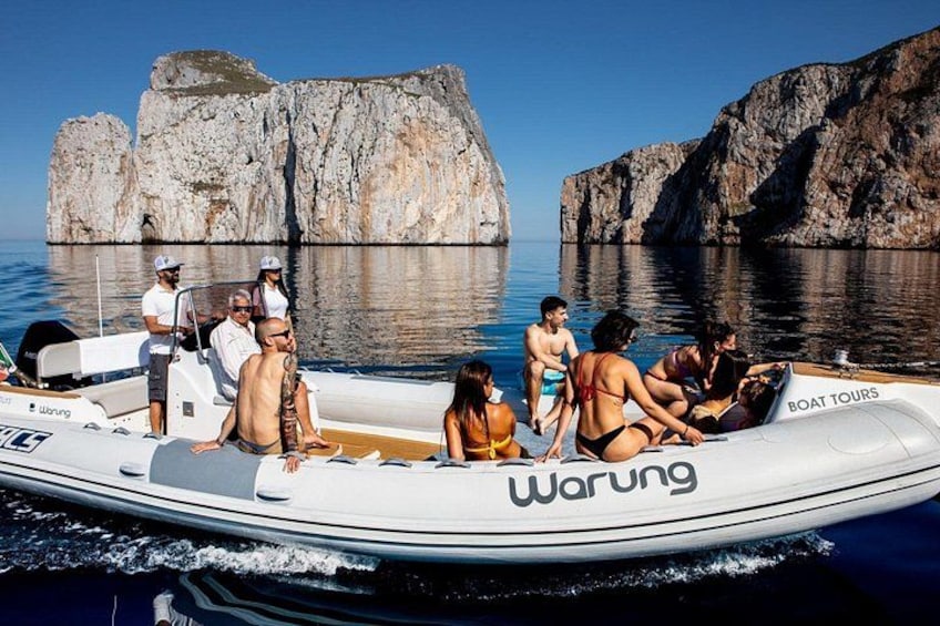 A boat tour with people on a small white boat, rocky cliffs in the background, and calm water. 3