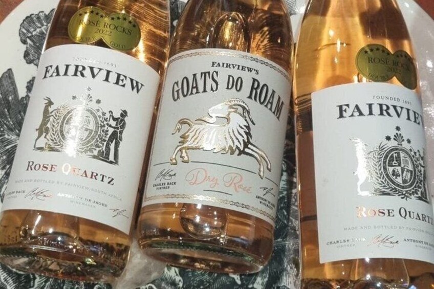 Three bottles of Fairview Rose Quartz wine with labels and a gold seal. 5