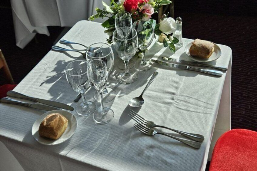 A table set for a meal with plates, cutlery, and glasses. 2