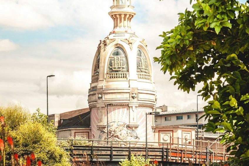 A historic building with a dome and a statue. 2