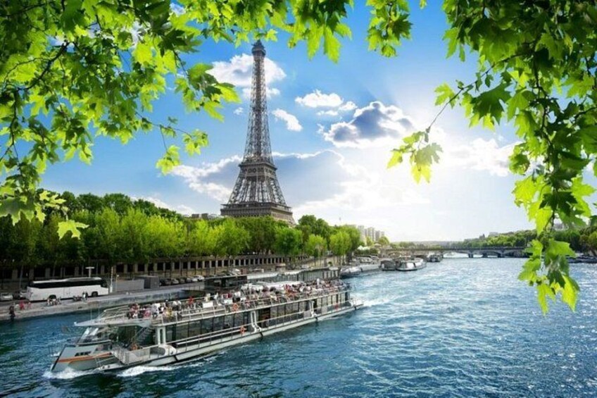 The Eiffel Tower, a river with boats, and a bridge. 2