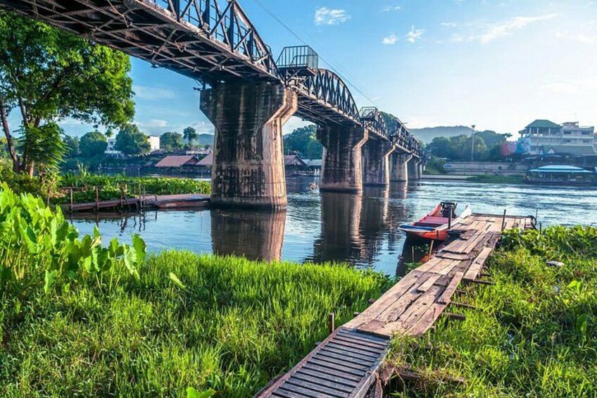 A bridge over a river with a dock and a boat. 2