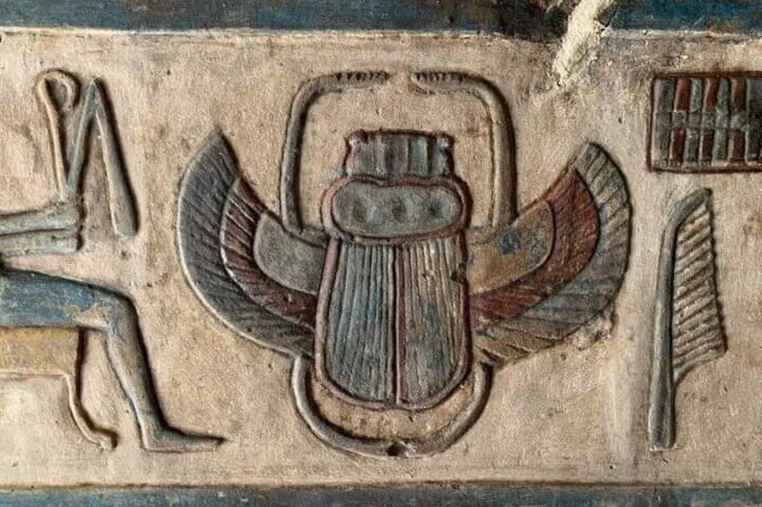 An ancient Egyptian relief with a winged scarab and hieroglyphs. 5
