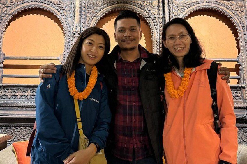 Three people standing in front of ornate architectural details. 5