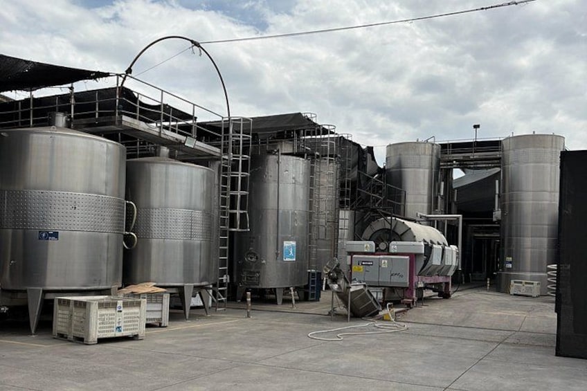 Industrial storage tanks, a ladder, and a forklift in a warehouse. 3