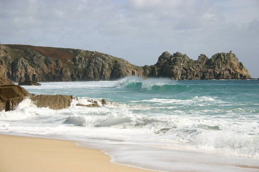 A rocky coastline with waves crashing onto the shore. 1