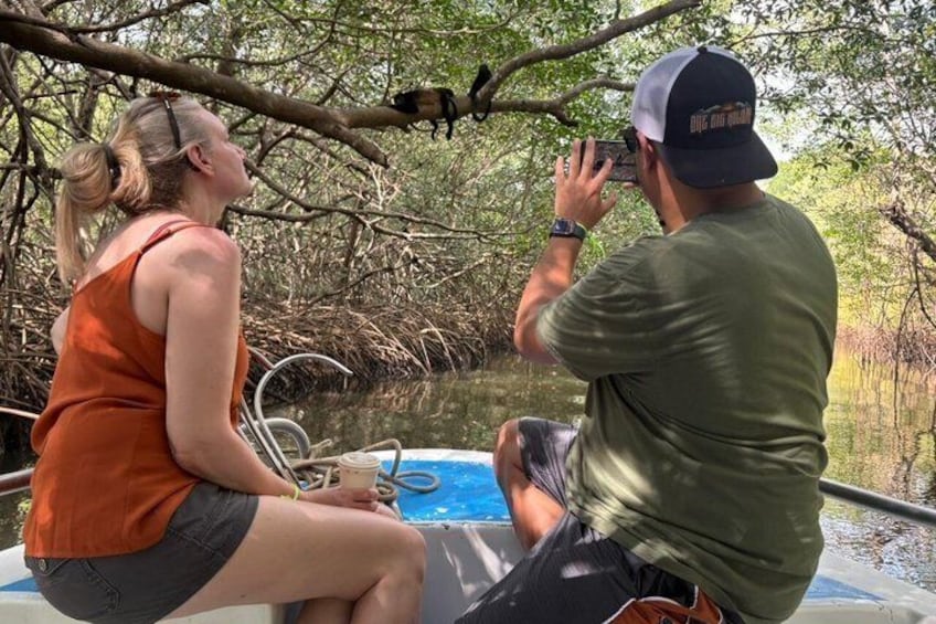 Two people on a boat in a mangrove area. 2