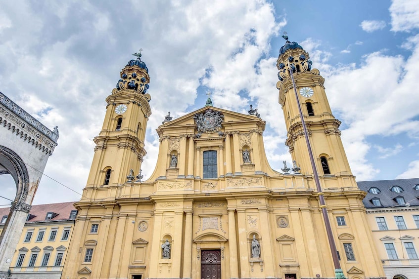 A historic church with two towers, a central dome, and a large arched entrance. 2