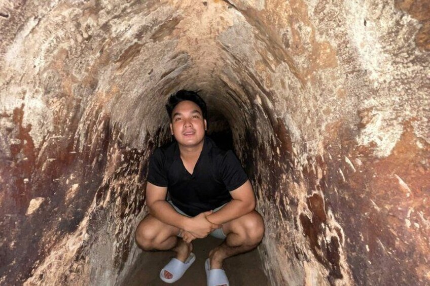 A person sitting inside a cave. 5