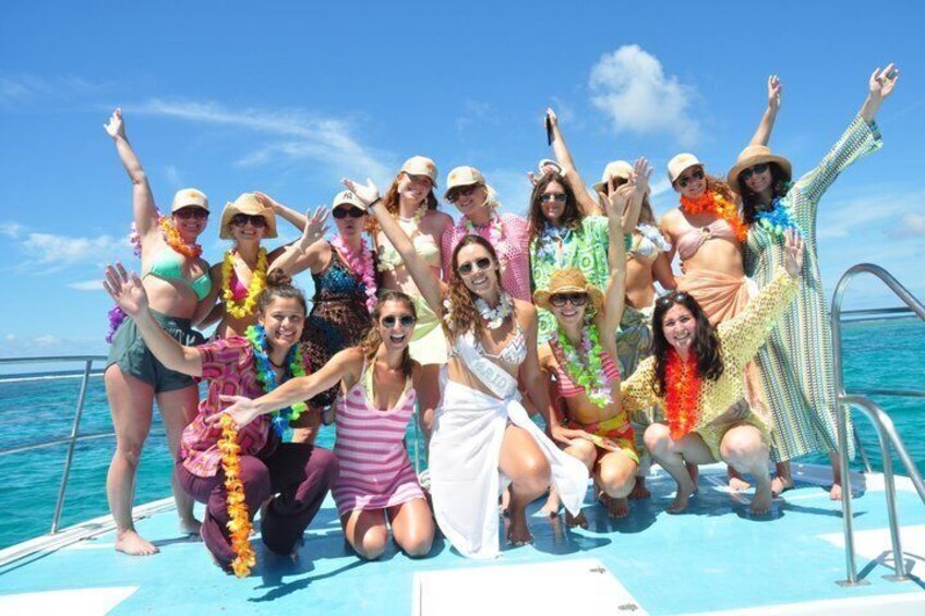 A group of people on a boat with the ocean in the background. 1