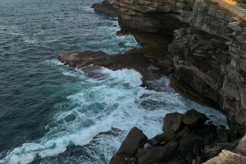 A rocky coastline with waves crashing against the rocks. 4