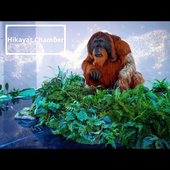 An orangutan sitting among lush green foliage in a glass enclosure. 2