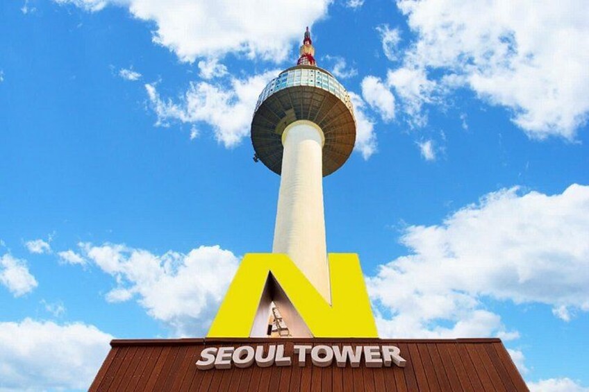 The Seoul Tower with a clear blue sky and clouds. 5
