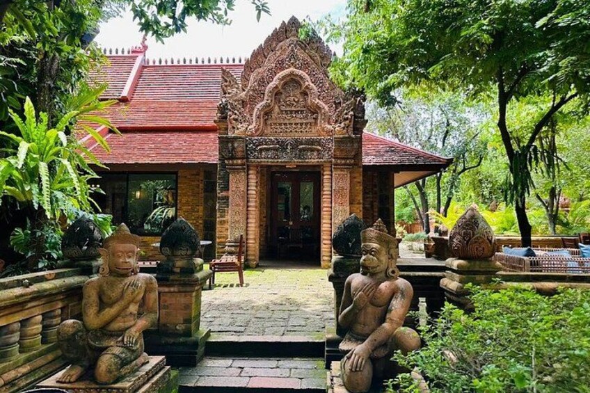 A traditional temple with intricate carvings, a red roof, and statues of deities. 3