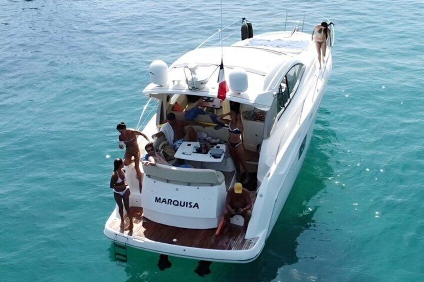 A white yacht named MARQUISA on calm turquoise waters. 2
