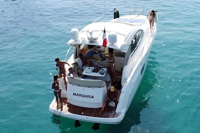 A white boat named MARQUISEA on turquoise water. 2
