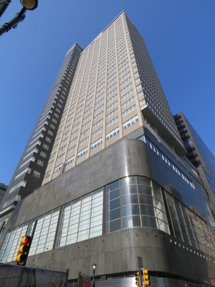 A tall, modern building with a curved facade and large windows. 3