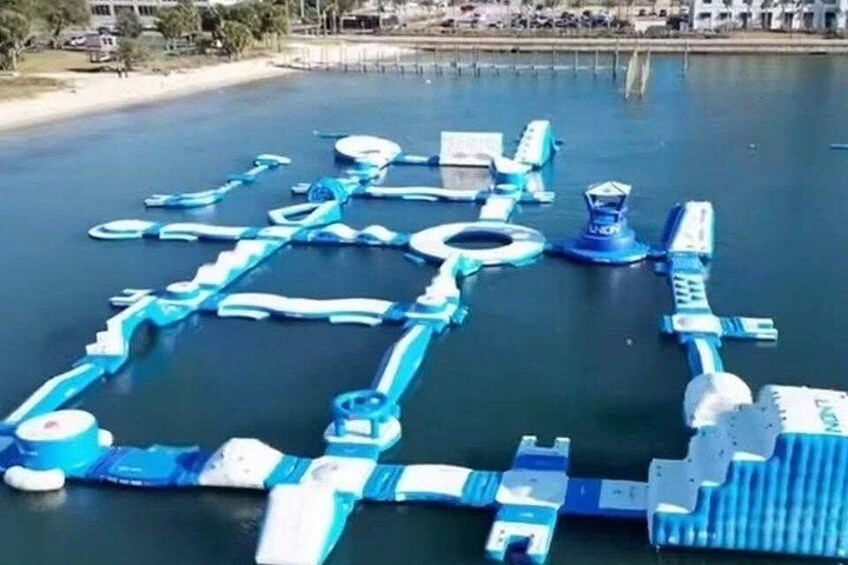 A water park with various blue and white water slides and structures. 2