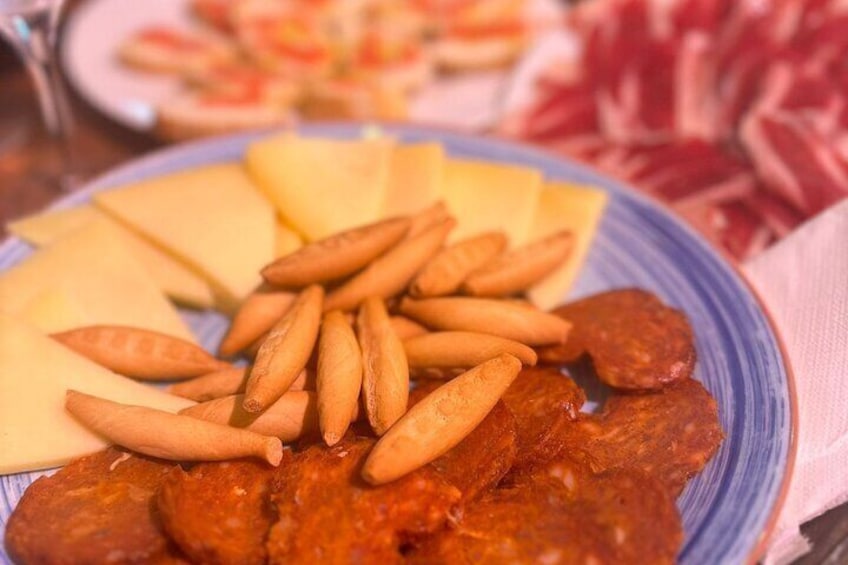 A plate of food with cheese, fries, and sausages. 4