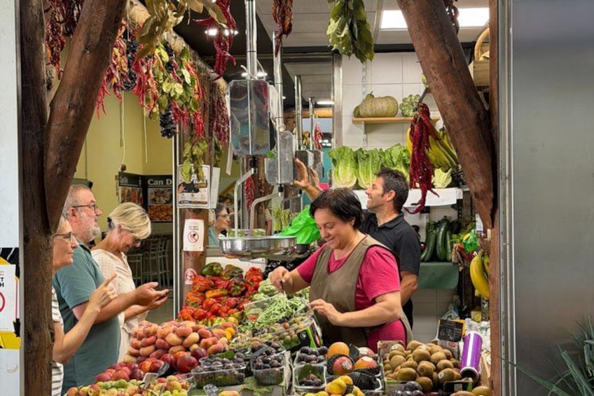 A market stall with fresh produce, including tomatoes, peppers, and other vegetables. 3