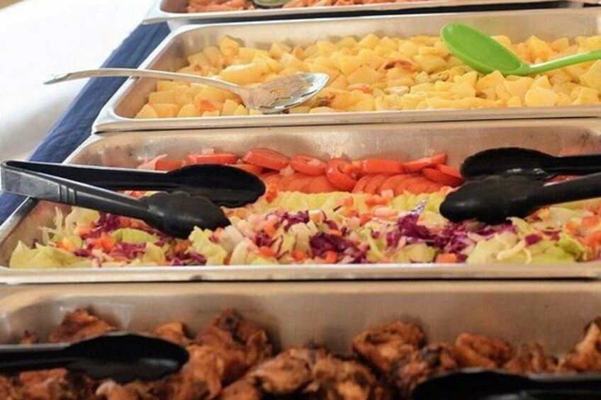 A buffet with various food items including cubed cheese, sliced carrots, coleslaw, and meat. 4