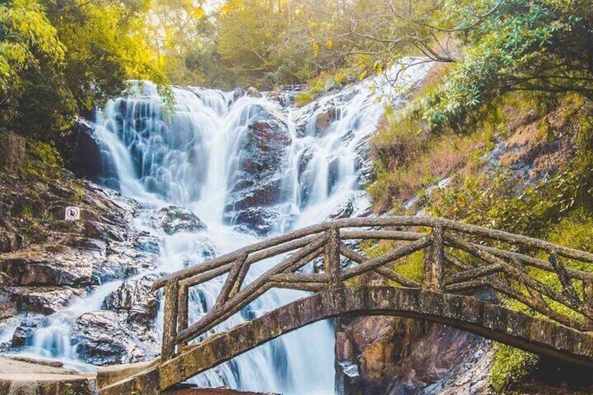 A waterfall with a wooden bridge. 5